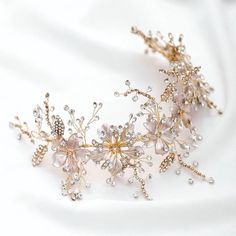 A beautiful piece of remarkable elegance, this exquisite headband is the perfect accessory for your Special Day. Adorned with a combination of glowing crystals, white pearls and enameled flowers, it gives your hair an extra touch of glam to finish off your perfect look on your perfect day. The possibilities are endless - at 11" (approx. 28cm) long and 3.5" (approx. 9cm) wide, it can be worn as a side headband, used as a tiara or wrapped around an intricate bun. The vines with crystals are flexib Gold Floral Headband, Bridesmaids Floral, Silver Wedding Hair Accessories, Gold Bridal Headband, Headpiece Bride, Headband Bride, Crystal Bridal Headband, Jewelry Princess, Brides Hair