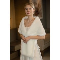 a woman is wearing a white fur stole