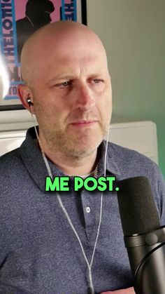 a bald man holding a microphone with the caption me post on his earphones