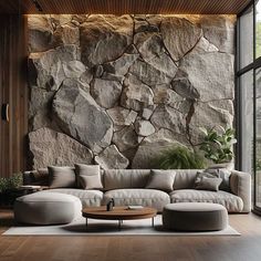 a living room filled with furniture and a stone wall behind the couches is a coffee table