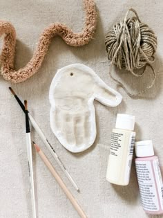 the supplies needed to make an easter bunny craft are laid out next to yarn, paint and crochet hooks