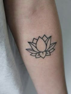 a black and white lotus tattoo on the arm