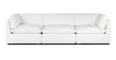 a white couch sitting on top of a white floor