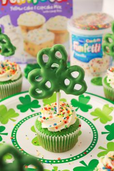 cupcakes decorated with green frosting and sprinkles on a st patrick's day plate