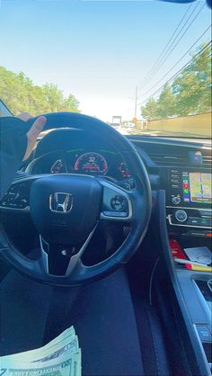 the interior of a car with an instrument, steering wheel and dash board in view