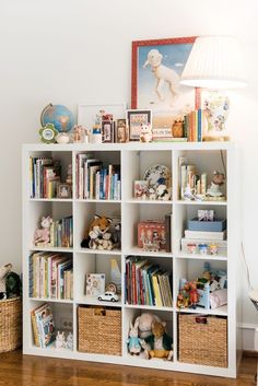 a bookshelf filled with lots of books and stuffed animals