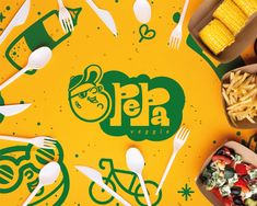 various foods are arranged in boxes on a yellow tablecloth with green and white lettering