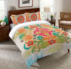 a bedroom with a bed covered in colorful floral comforter and matching pillow shampoos