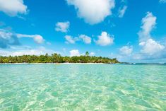 an island in the middle of clear water