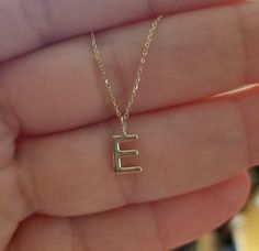 "14K SOLID YELLOW GOLD DAINTY INITIAL NECKLACE Metal : 14K Solid Gold Necklace Length : 16 inches / 40cm Letter Height : 9.00mm Letter Width : 6.55mm ---MADE IN USA--- ---All letters from A to Z are available. Please indicate your letter choice in the \"notes to seller\" section on the order. ---This is a beautiful 14K Solid White Gold Dainty Initial Necklace with Diamonds. Available White Gold -Yellow Gold or Rose Gold ---Absolutely stunning. Comes in a gift box. ---Shipping Policy---- Item wil E Necklace Initial, Gold E Necklace, Letter E Necklace, E Initial Necklace, E Necklace, Initial Necklace Gold Letters, Gold Ruby Necklace, Dainty Initial Necklace, Unusual Necklace