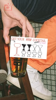 a person sitting on a chair holding up a sign with the words get your 9th cocktail