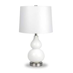 a white table lamp with a white shade on the base and a silver metal base