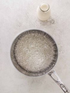 a frying pan filled with food next to a bottle of milk