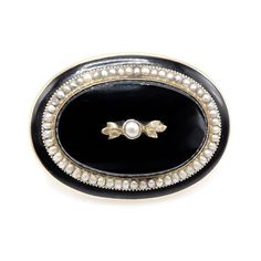 This oval Victorian brooch is made of 10K yellow gold, black enamel, and pearls and is a beautiful and pristine example of turn of the century mourning jewelry. Its true appeal, however, is that just under the pin mechanism on the back, the name "M.E. Flanagin" is engraved. We did some digging and one name came up. Martha E. Flanagin, who died in 1904, was the widow of the first post-Civil War governor of Arkansas, Harris Flanagin. While there's no way to guarantee that this brooch belonged to, Antique Black Brooch For Evening, Antique Black Evening Brooch, Antique Black Brooches For Evening, Classic Black Brooches For Wedding, Classic Black Wedding Brooch, Classic Black Wedding Brooches, Luxury Black Wedding Brooches, Elegant Black Cameo Brooches, Antique Black Brooch For Wedding