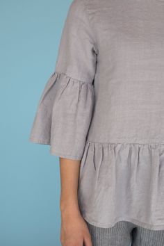 "MsWrinkle's clothing - from human to human. 100% handmade. *Description* - Linen blouse with ruffles and cute bow on the back; - High quality European linen; - Washed and softened (doesn't shrink anymore); - Medium weight linen (150 g/m2); - Our linen is OEKO-TEX certified that meets human ecological safety requirements; - Model is wearing size S in elephant grey (other sizes and colors please choose on the right); - Not transparent; - Not ironed and we suggest to use tumble dryer to keep soft Short Sleeve Linen Blouse With Ruffles, Relaxed Fit Linen Top With Ruffles, Linen Blouse With Rolled Sleeves And Button-up Shape, Cotton Ruffle Button-up Blouse, Linen V-neck Tops With Ruffles, Blouse With Ruffles, Ruffle Sleeve Top, Loose Fit Blouse, Linen Summer