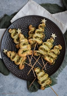 an image of christmas treats on a plate with the title text overlay that reads puff pastry pesto christmas trees