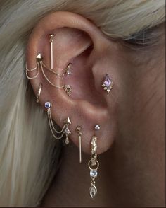 an ear with several different piercings attached to it's sides and on the other side