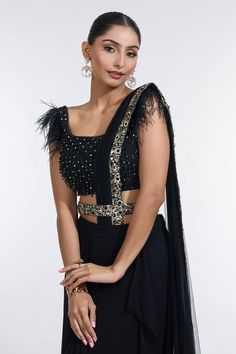 Black pre-draped skirt saree with confetti sequin embroidered palla border. Paired with a ostrich feather embellished short sleeves bead embellished blouse and a sequin embellished belt. - Aza Fashions Sarees Black, Skirt Saree, Net Embroidery, Embellished Shorts, Embellished Belt, Drape Saree, Embellished Blouse, Draped Skirt, Beaded Neckline