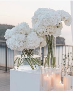 some white flowers and candles on a table