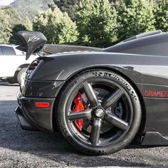 a black sports car parked in a parking lot