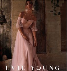 a woman in a pink dress is posing for the cover of an article about evening gowns