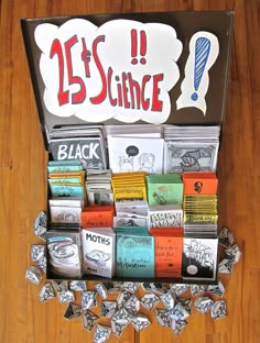 an assortment of different types of candy in a box on a wooden floor with the words 25's science written above it