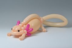 an inflatable toy rat laying on its side