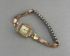 This running 1940s ladies wristwatch by Tavannes of Switzerland features a 14 karat rose gold case, set with six clear, sparkly diamonds. The watch band is gold-filled, and it currently fits a smaller wrist. This band can be replaced, if needed. *Please note: This watch winds up and runs, and it keeps good time. As with all vintage analog watches, I recommend having this watch cleaned and serviced by a watchmaker to ensure accuracy.* The watch case measures about 1 inch long, and the inside of the case back is marked Tavennes 14 K Gold. This watch is in very good original condition, with all diamonds original to the watch. Please see photos for details. US buyers only, please. Free shipping. 1940s Woman, Analog Watches, Pretty Accessories, Watch Jewelry, Rose Gold Case, Analog Watch, Gold Case, Women Wrist Watch, Watch Case