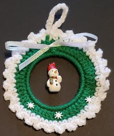 a crocheted christmas ornament with a snowman on it