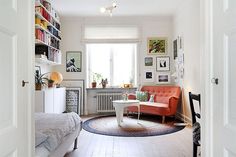 a living room filled with furniture and lots of books on the shelves next to a window