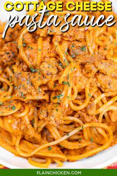 pasta with meat and sauce in a white bowl on top of a red checkered table cloth