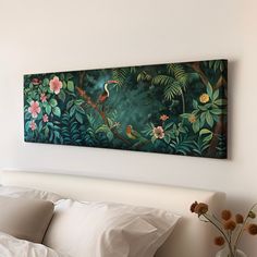 a painting hanging on the wall above a bed