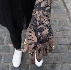 a person's hand with a tattoo on it