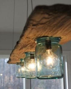 mason jar lights hanging from a wooden beam