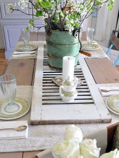 the table is set with flowers and plates