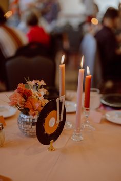 the table is set with candles and plates