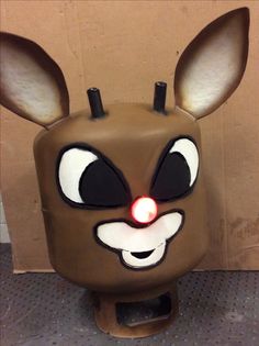 a brown mask with ears and eyes on it