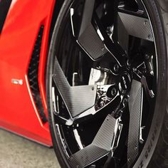 the front wheel of a red sports car