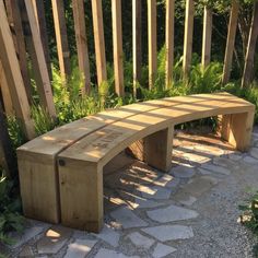 a wooden bench sitting on top of a stone walkway