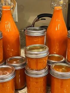 there are many jars that have orange liquid in them