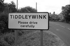 a sign that says tideywink please drive carefully on the side of the road