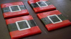 three red and black coasters sitting on top of a table