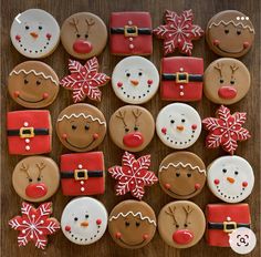 decorated cookies arranged in the shape of santas and snowmen on a wooden table