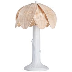 a white table lamp with a large flower on it's base and a light bulb in the middle