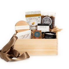 a wooden box filled with lots of different types of food and confection items