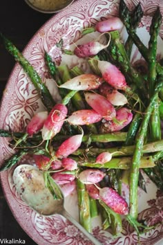 asparagus and pink flowers on a plate