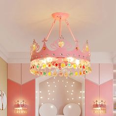 a bedroom with pink walls and white bedding has a princess's crown on the ceiling