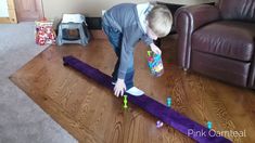 a little boy playing with toys on the floor