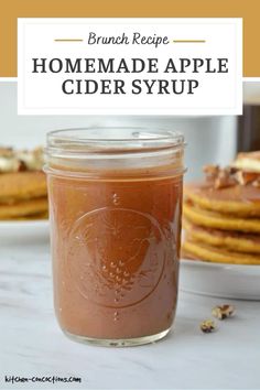 a jar filled with homemade apple cider syrup on top of a table next to pancakes