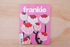 the front cover of a magazine with flowers painted on it's back and pink background